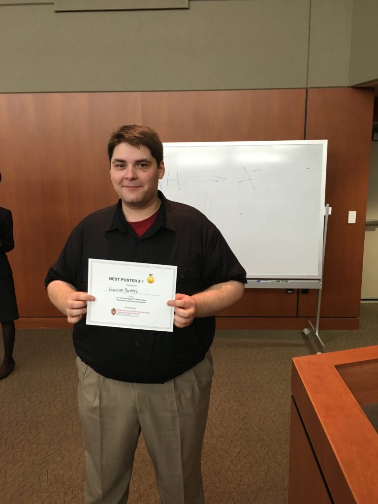 Student holding award